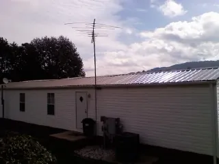 New metal roof on a single wide mobile home with a TV antenna in Winthrop