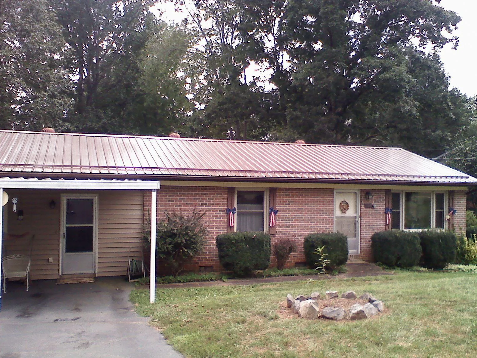 Bronze metal roof and carport on a brick ranch home — Roof Repair work by our crew in Winthrop